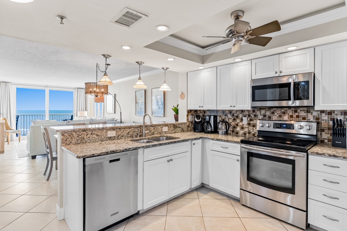 Your fully equipped kitchen features granite countertops, stainless appliances, and ocean views that make meal prep a joy.