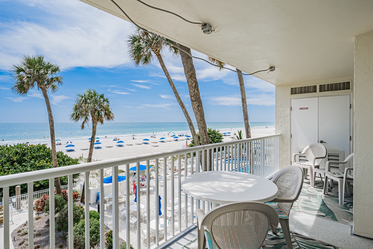 Sip your morning coffee on this beachfront balcony while watching palm trees sway and waves roll in just steps away—your perfect coastal escape awaits.
