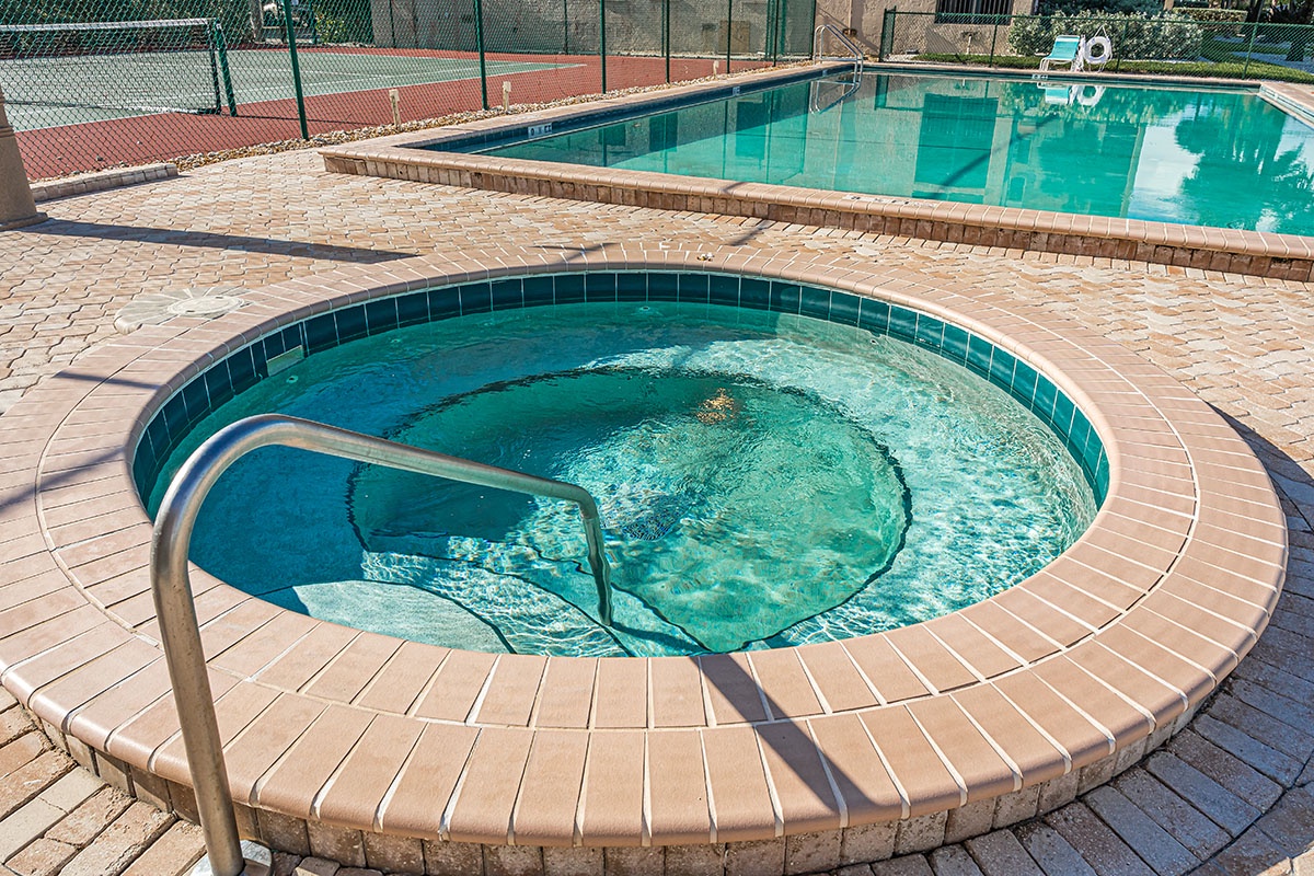 Soak your stress away in this inviting hot tub, perfectly positioned beside the sparkling pool for the ultimate relaxation experience.