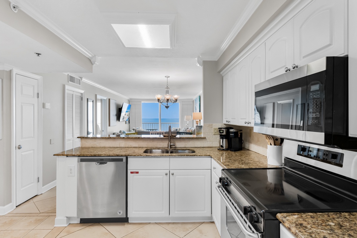 Cook with ocean views through your kitchen window, featuring granite countertops and stainless steel appliances for memorable meals.