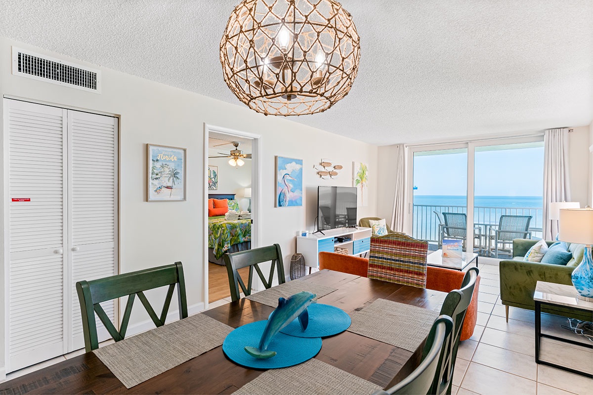 Your open-concept dining and living space features ocean views, coastal décor, and comfortable seating for memorable beachside gatherings.