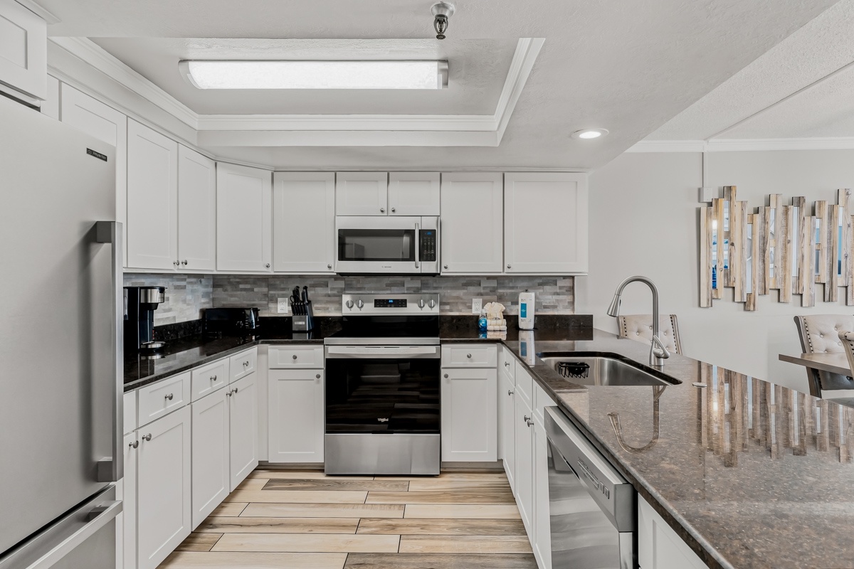 Your fully equipped kitchen features modern appliances, generous counter space, and sleek finishes—perfect for whipping up everything from morning coffee to memorable meals during your stay.