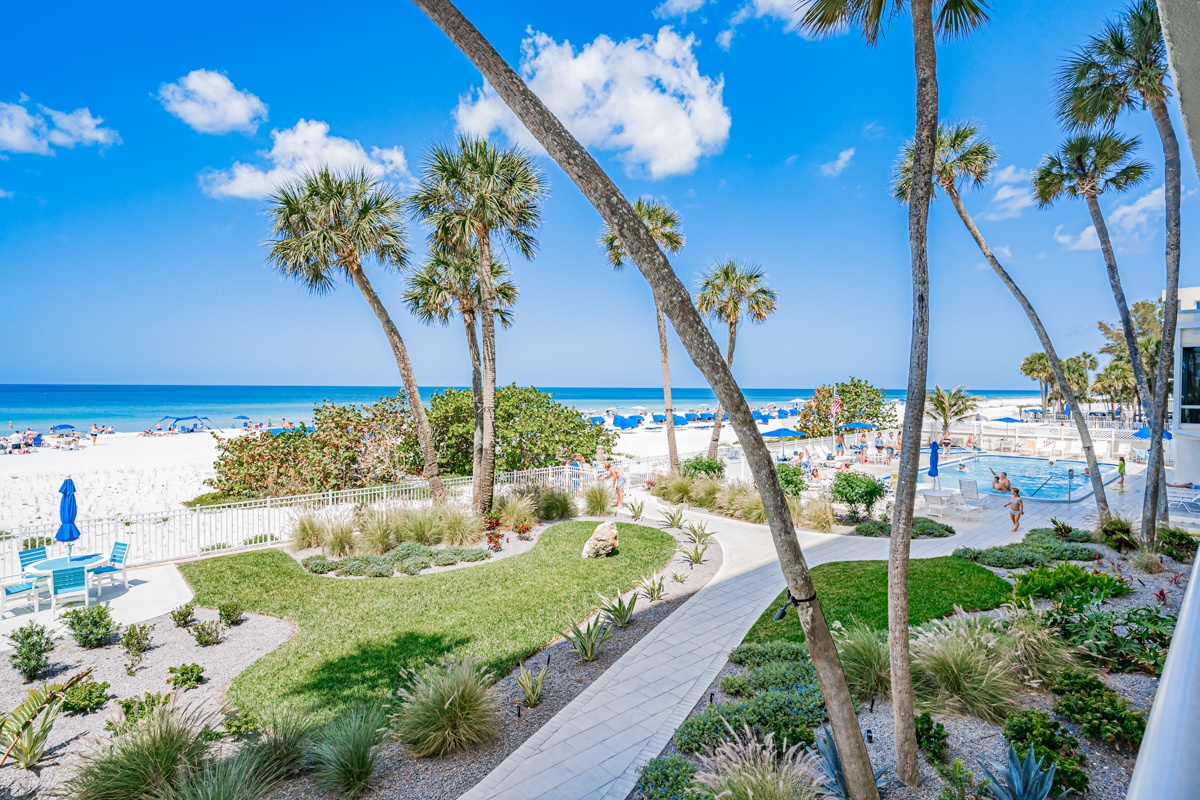 Tropical paradise awaits with pristine white sand beach, swaying palms, and crystal-clear waters just steps from the property.