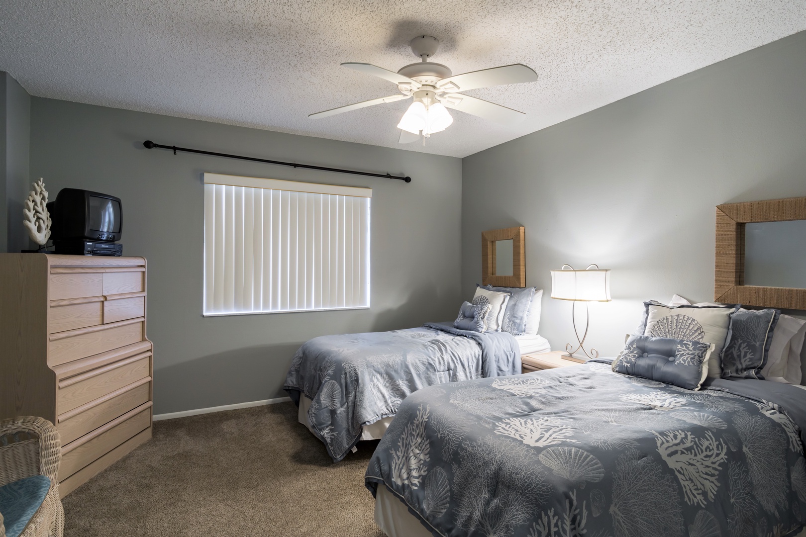 The Second Bedroom has two twin beds, a ceiling fan, and a Roku smart TV.