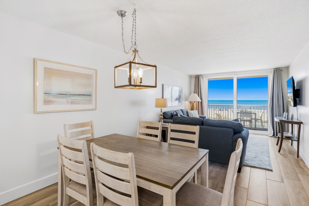 Gather around your dining table while soaking in stunning ocean views through floor-to-ceiling windows that frame the endless blue horizon.