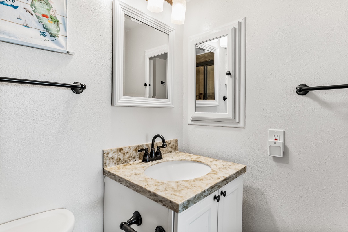 Refresh in your private bathroom featuring modern fixtures, granite countertops, and convenient grab bars for comfort and safety.