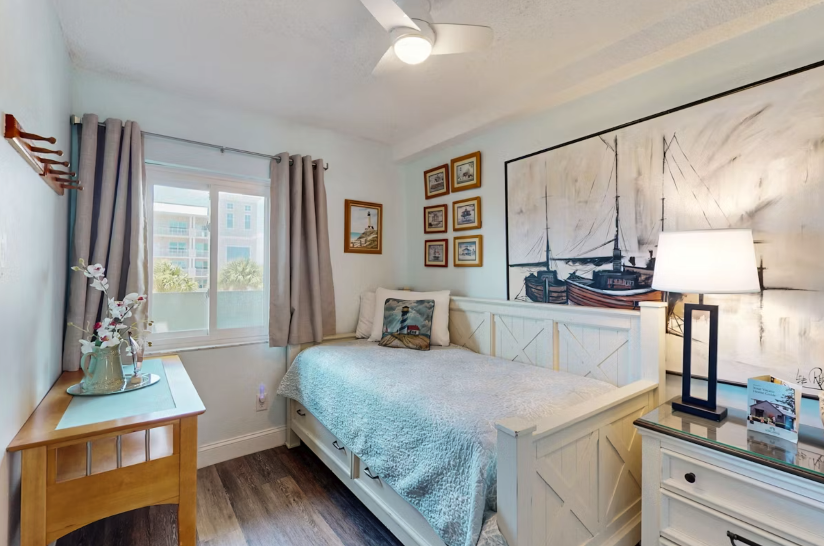 Unwind in this serene coastal-themed Twin bedroom with soft linens, charming nautical decor, and plenty of natural light to help you drift into a peaceful, restful sleep.