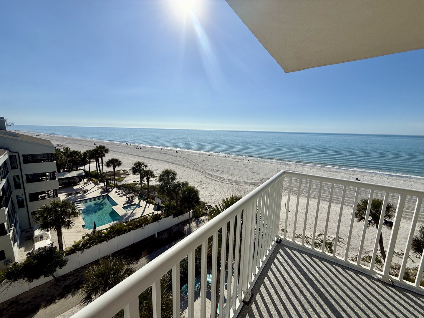 Wake up to this breathtaking ocean panorama from your private balcony, where endless blue waters and pristine sand create your daily paradise.