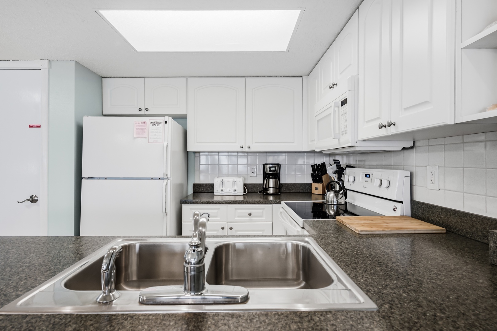 Your fully equipped kitchen features everything you need to prepare meals at home, with a bright skylight overhead and ample counter space for cooking and gathering together.