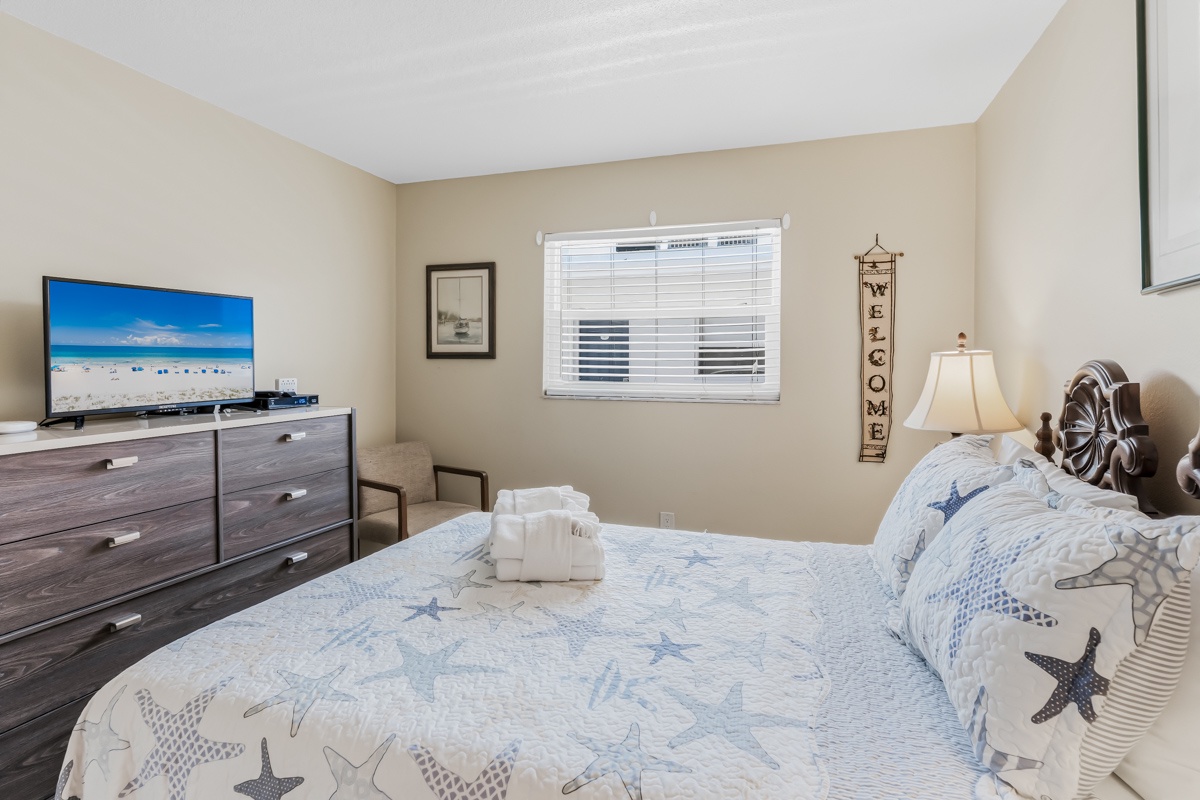 Sink into a comfy bed adorned with coastal charm after a day of adventure. Your beachside bedroom welcomes you with soft linens, warm lighting, and thoughtful touches to make every moment feel like home.
