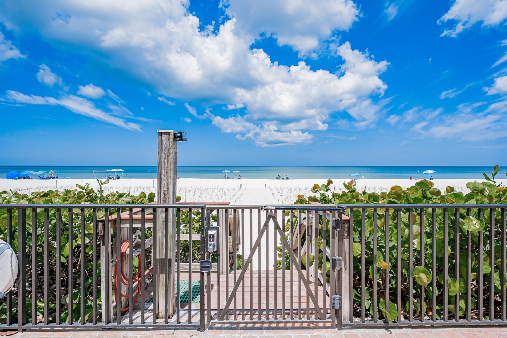 Beachfront property offering direct access to pristine white sand and turquoise waters, with an outdoor shower for rinsing off after ocean swims.