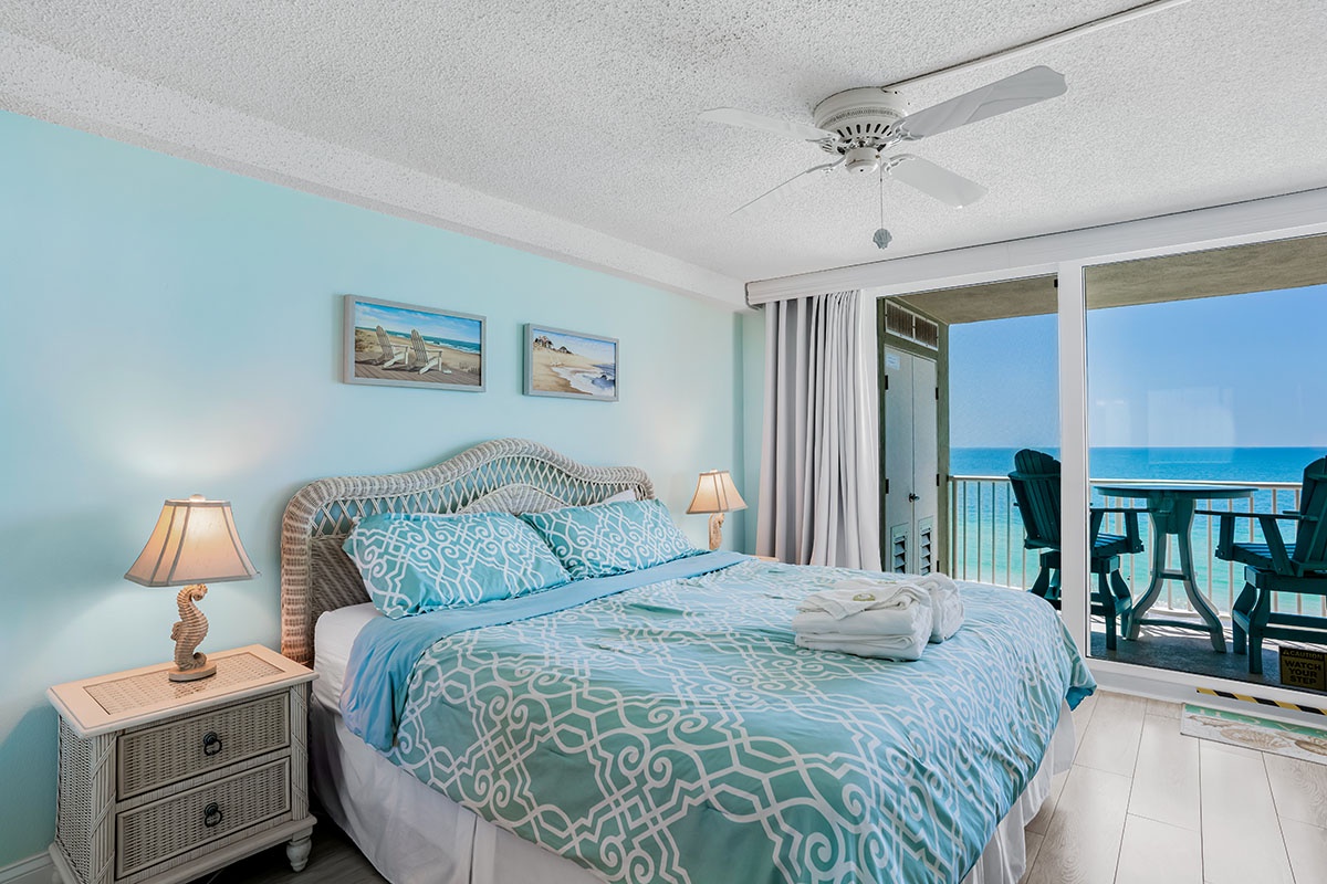 Wake up to endless ocean views from your coastal bedroom, where turquoise bedding mirrors the sea beyond your private balcony.