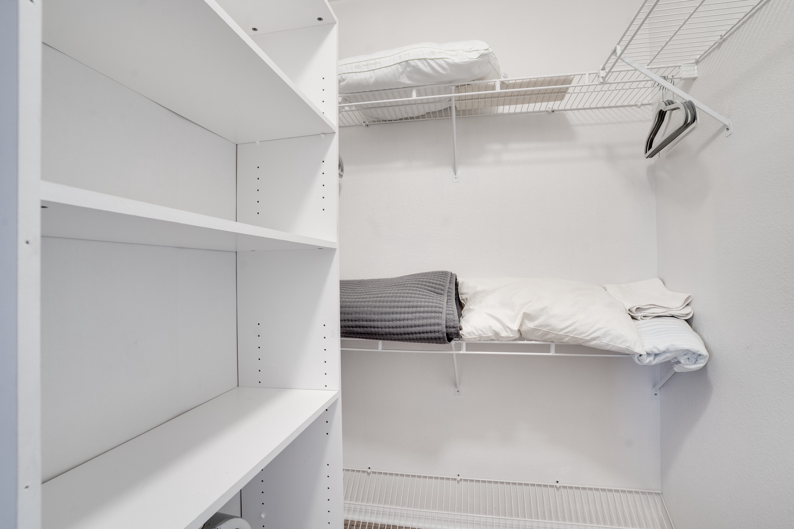 Your spacious walk-in closet offers organized shelving and hanging space, keeping your belongings perfectly arranged during your stay.