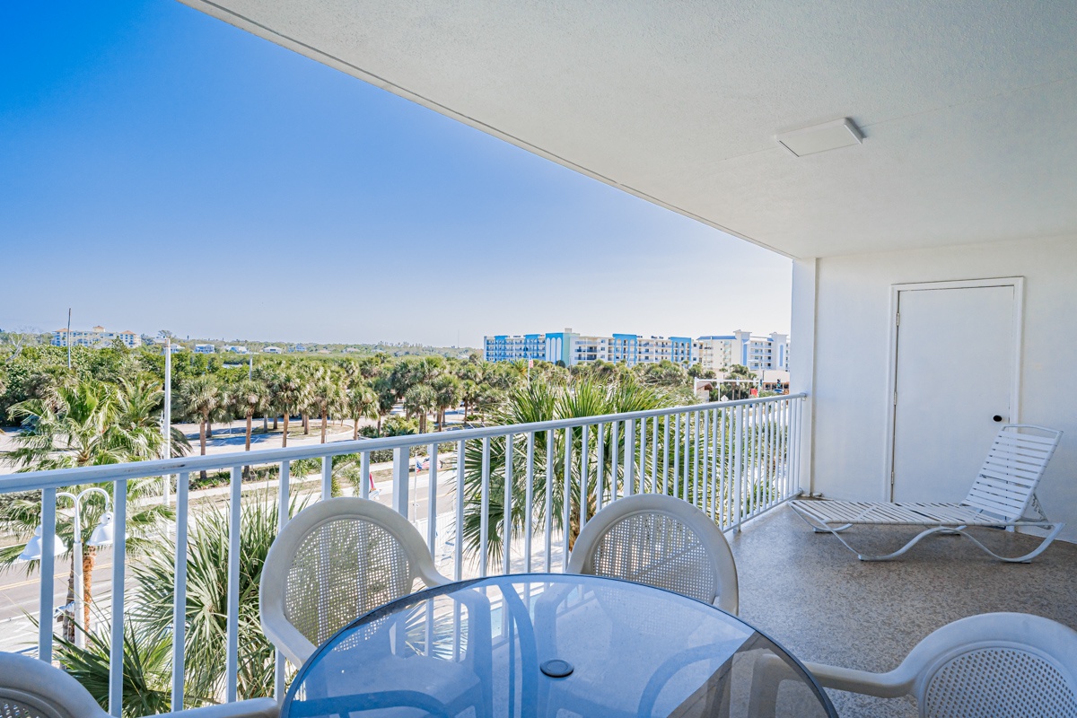 Unwind on your private balcony with comfortable seating and peaceful tropical views stretching to the horizon.