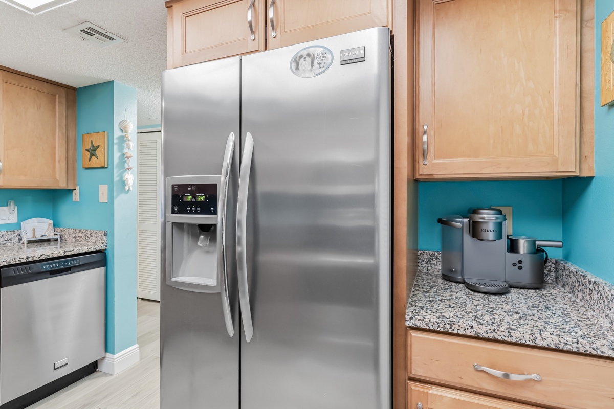 Whip up your favorite meals in this bright, fully equipped kitchen featuring stainless steel appliances, granite countertops, and cheerful coastal colors that make cooking a pleasure.
