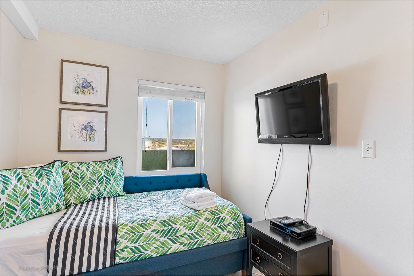 3rd bedroom has mounted TV