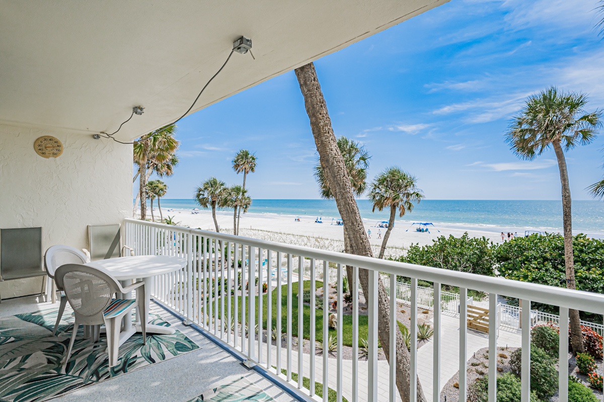Step onto your private balcony and let the ocean breeze greet you. Settle into your chair, breathe in the salty air, and watch palm trees sway above the white sand while gentle waves lap at the shore just steps away.