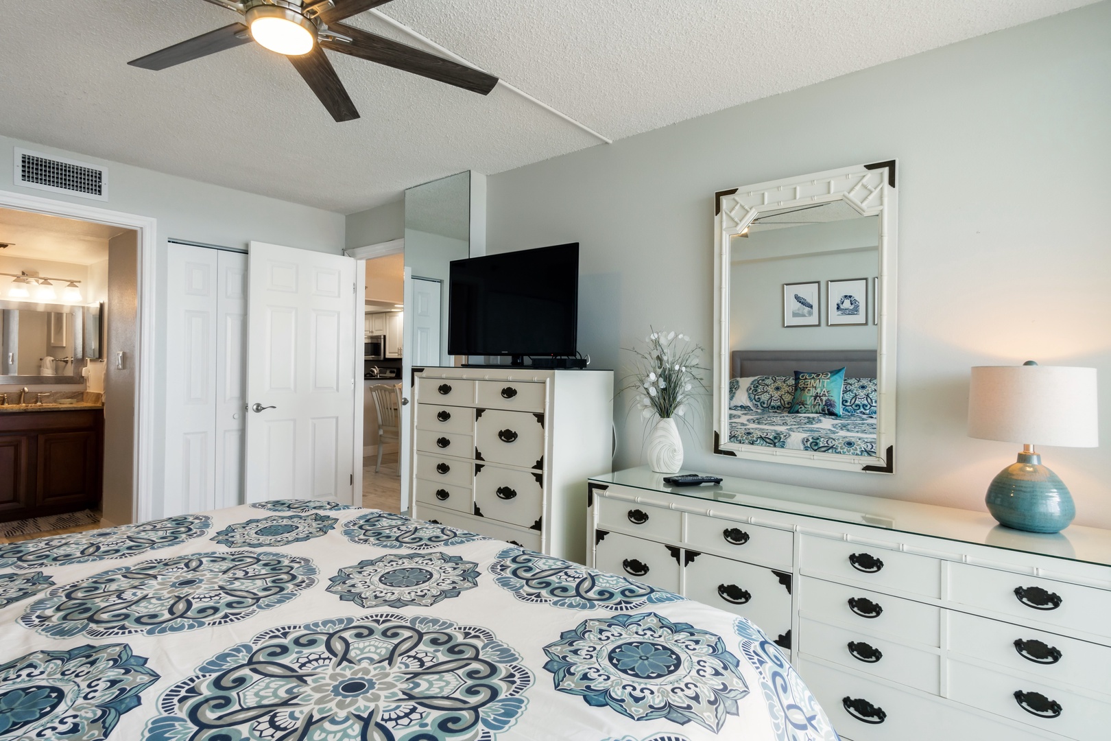 Master bedroom has ceiling fan and TV