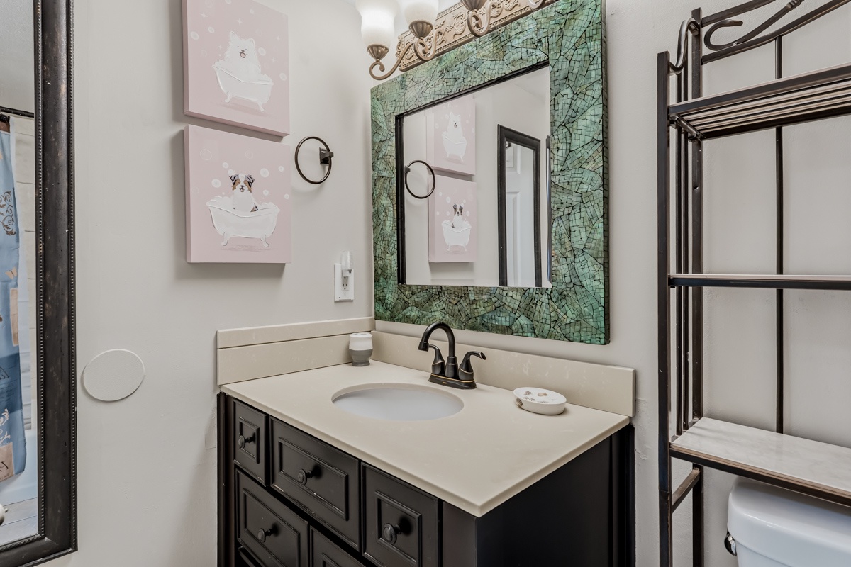 Refresh in your private bathroom with charming coastal décor, a beautiful mosaic mirror, and plush towels ready for you.