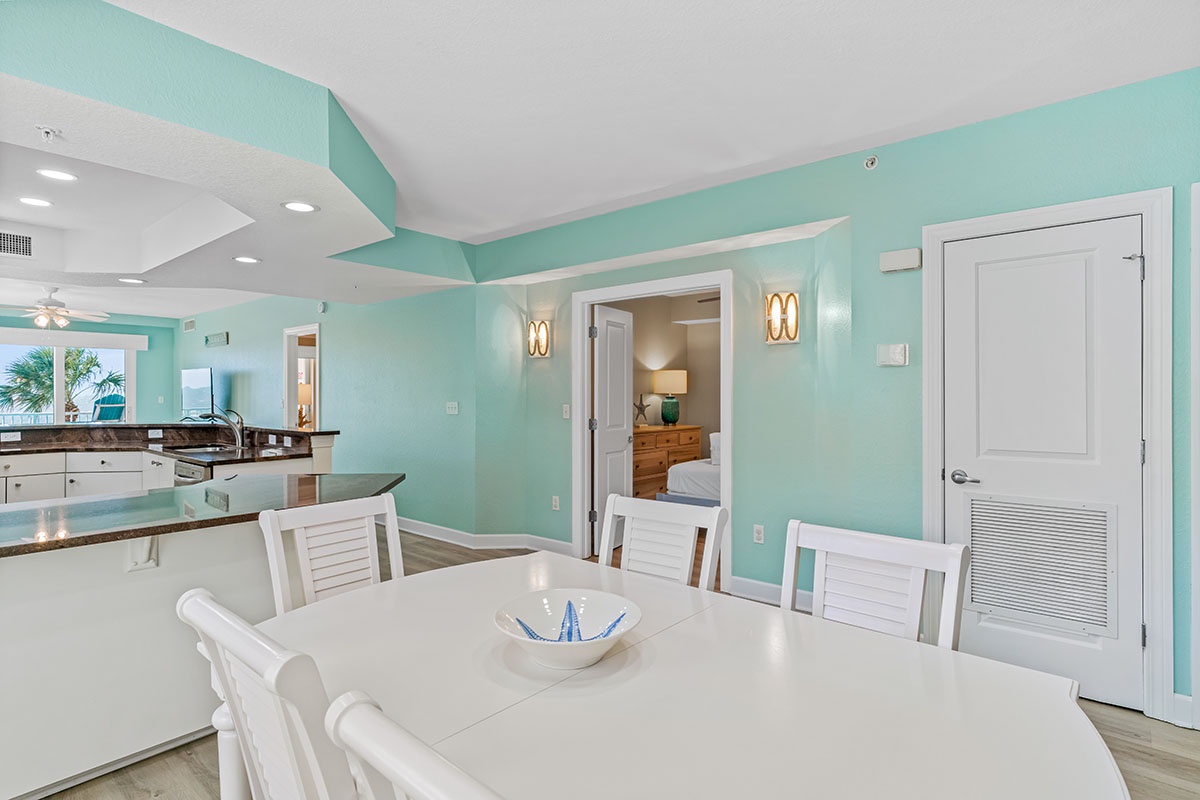 Gather around this coastal-inspired dining space where mint walls and white furnishings create a fresh, beachy vibe for your memorable meals together.