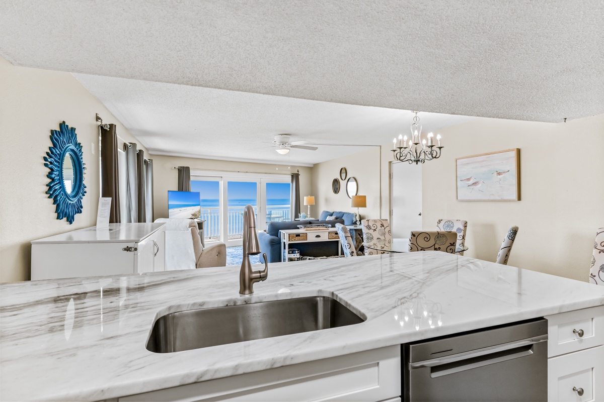 Your elegant kitchen opens to stunning ocean views, where marble countertops and stainless appliances make cooking a joy.