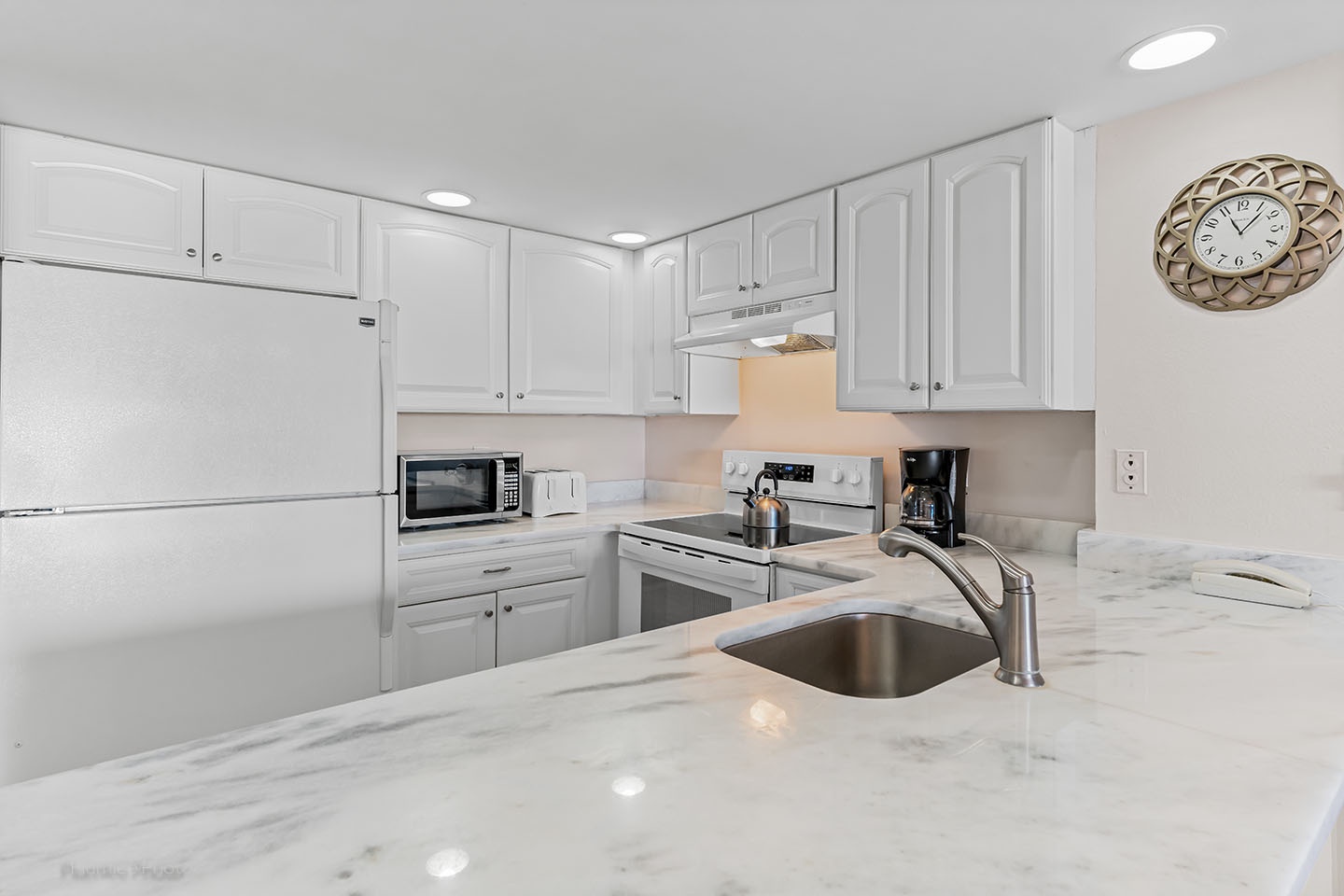 Stone counters and white cabinets