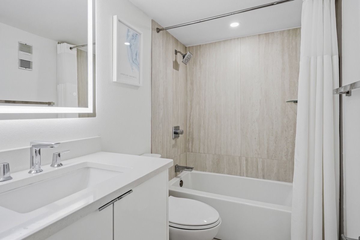 Step into your spa-like bathroom featuring a luxurious soaking tub, rainfall shower, and sleek modern finishes for ultimate relaxation.