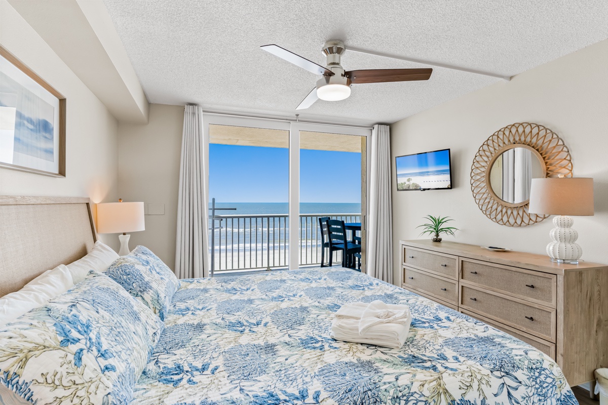 Wake to stunning sea views from your oceanfront King bedroom, where soothing blue linens and coastal decor create perfect beachside tranquility.