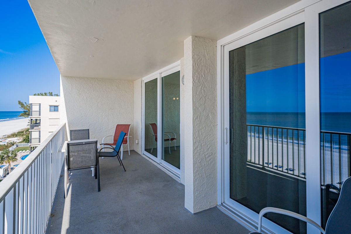 Your private balcony offers stunning ocean views with comfortable seating where you can unwind and watch the waves.