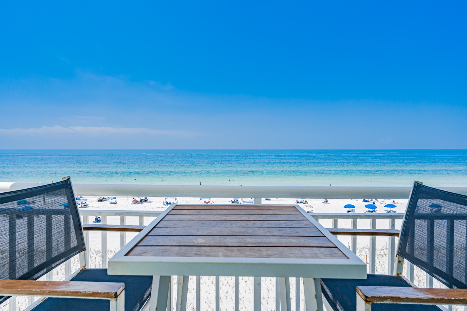 This beachfront property offers direct access to white sandy shores and crystalline Gulf waters, with a spacious deck just steps from the coastline.