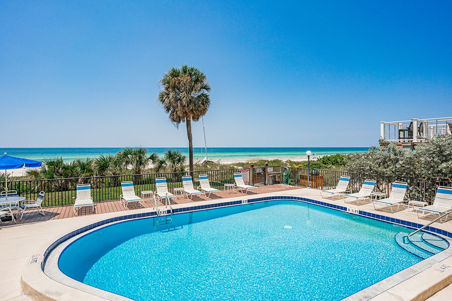 The pool deck with the Gulf of Mexico in the background.