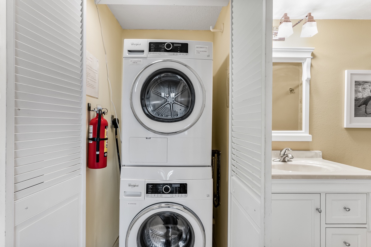 You'll find a front load stacked washer and dryer tucked behind sleek louvered doors, keeping laundry simple and stress-free during your stay.
