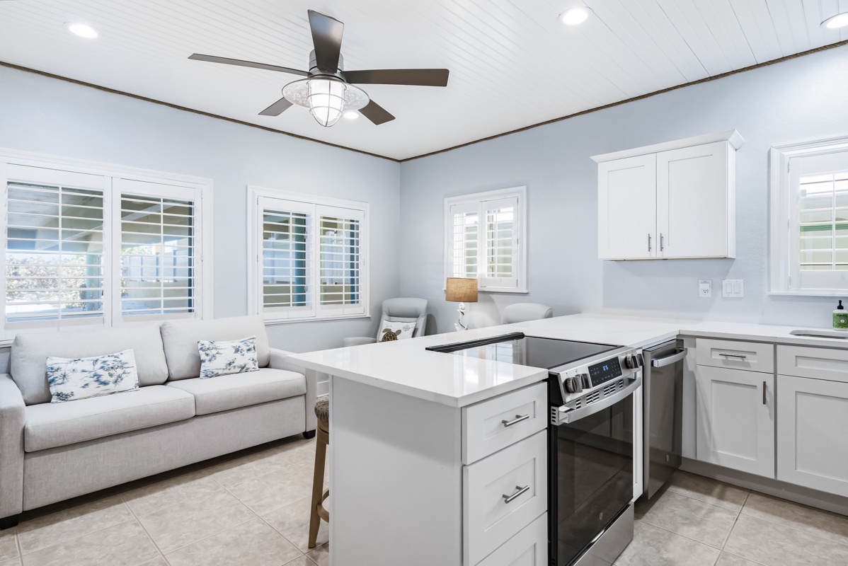 Your bright open kitchen flows seamlessly into a cozy living area, perfect for cooking and relaxing together.