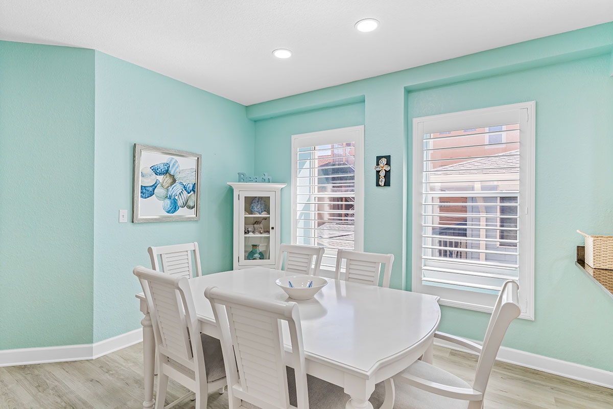 Your bright dining space features calming mint walls and elegant white furnishings, creating the perfect spot for memorable meals together.