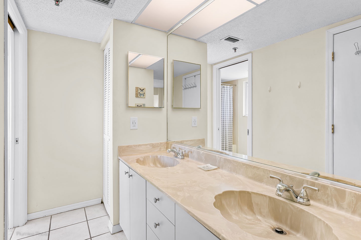 The master bathroom has double vanity sinks.