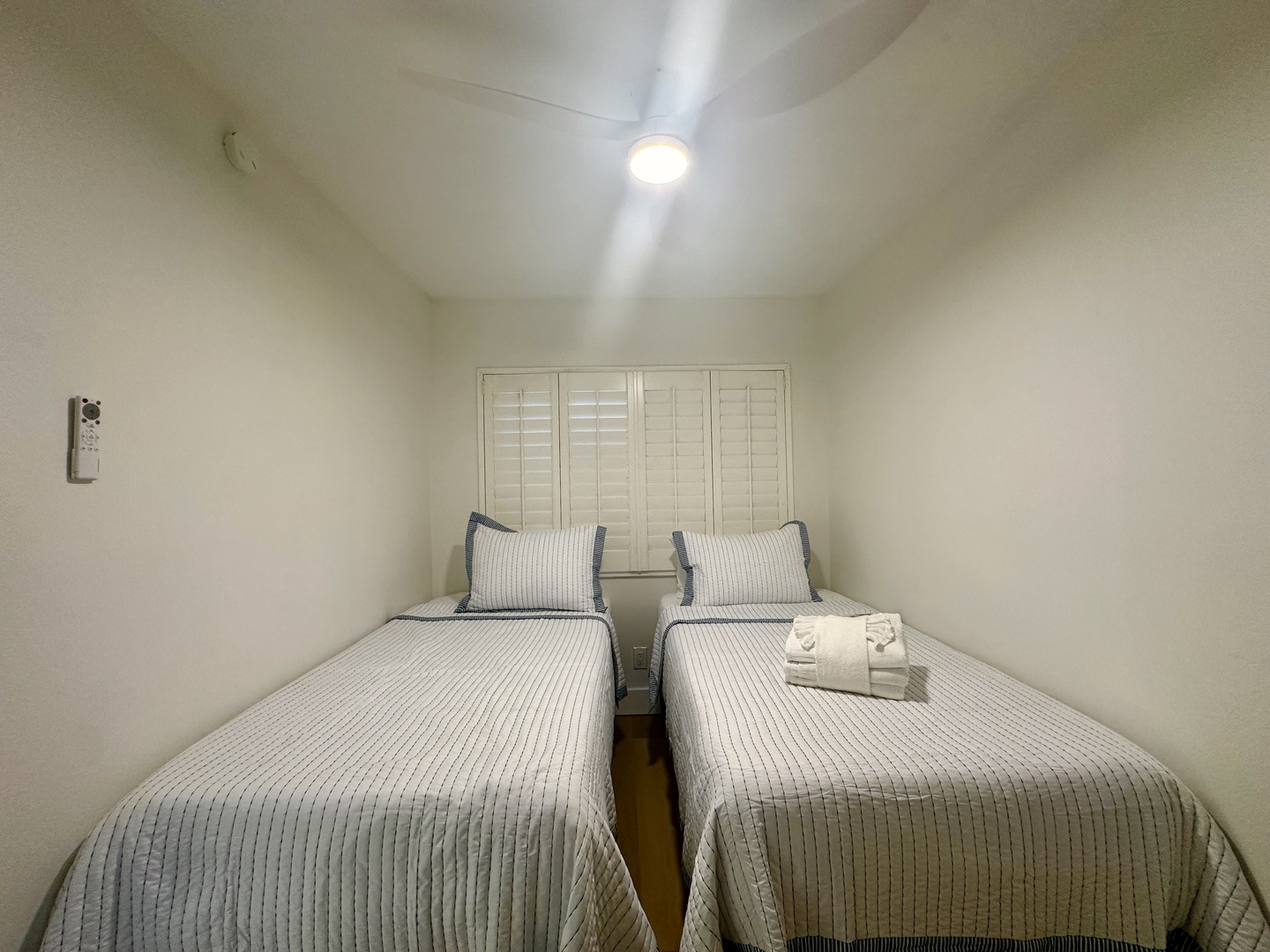 Rest peacefully in your twin bedroom with crisp linens and soft textures creating a serene atmosphere for quality sleep.