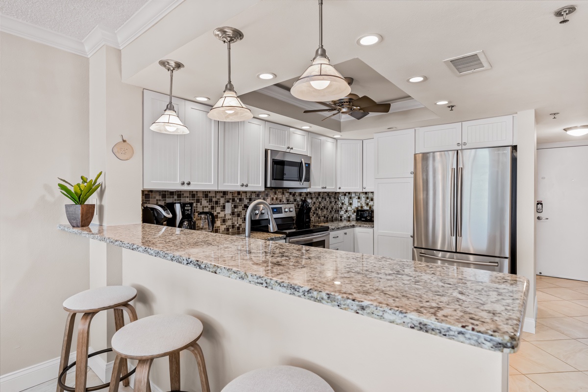 Your fully equipped kitchen features granite countertops, stainless steel appliances, and elegant pendant lighting for memorable meal prep.