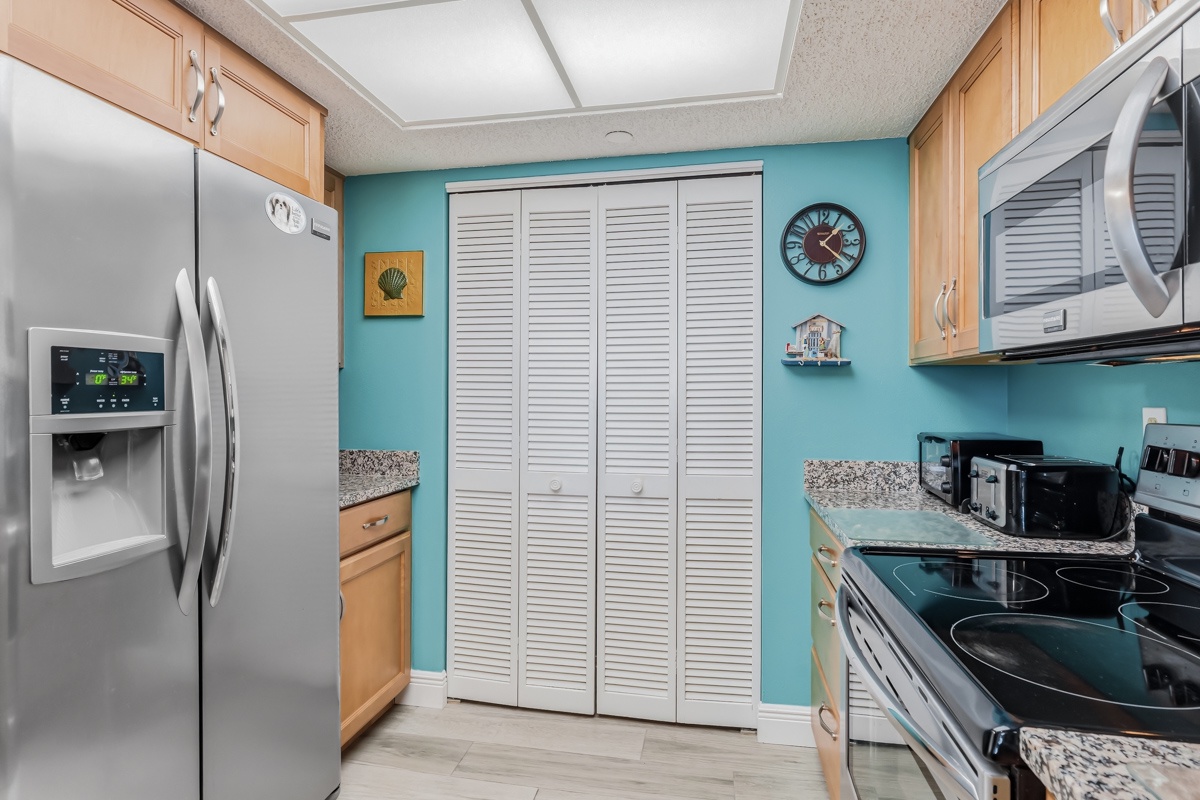 Your fully equipped kitchen features modern stainless steel appliances, granite countertops, and plenty of cabinet space, making it easy to prepare home-cooked meals during your stay.