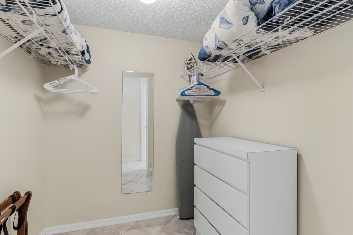 Your walk-in closet offers generous storage with wire shelving, hangers, and a mirrored door to help you organize and prepare for each day with ease.