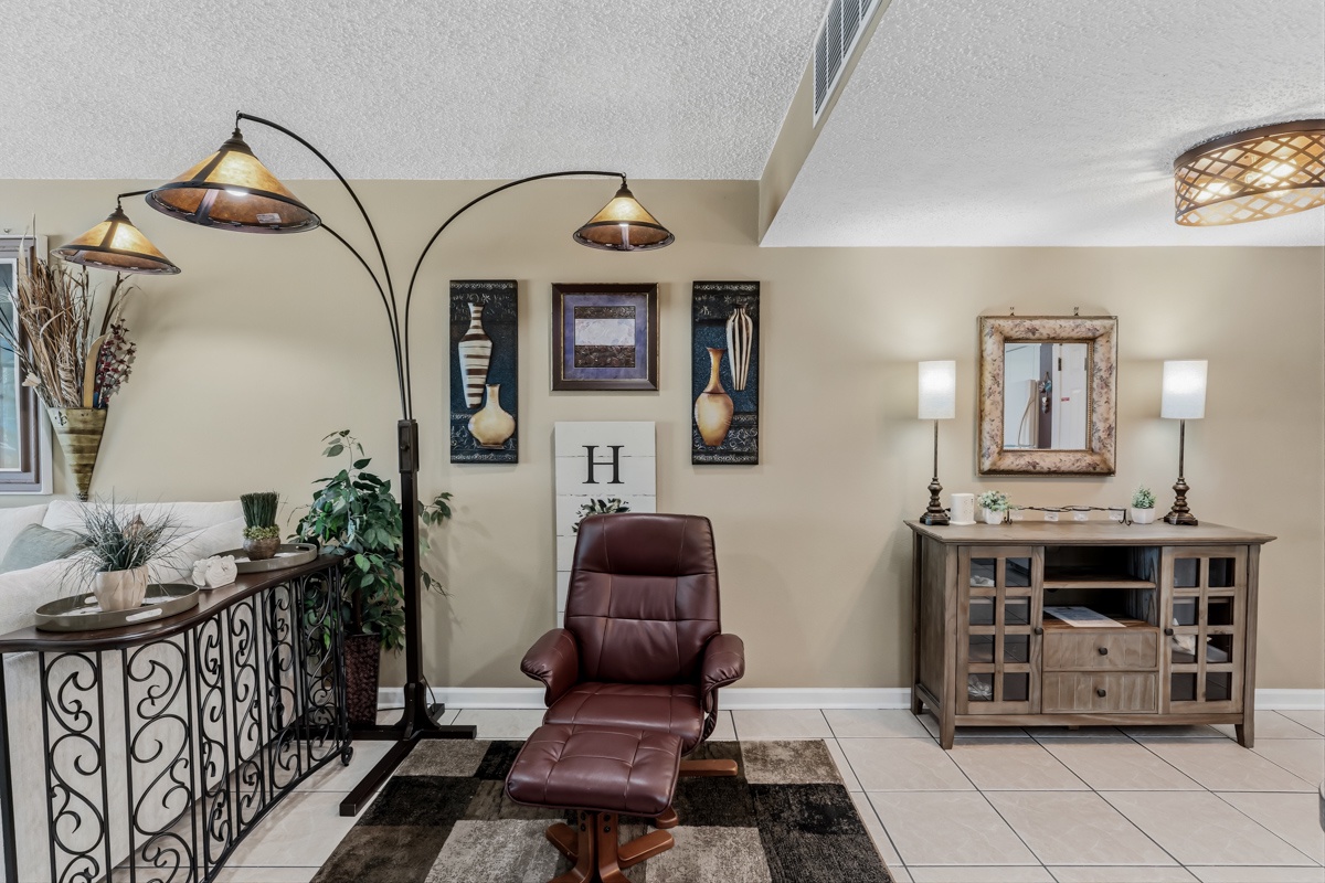 Settle into your favorite chair with a good book under warm ambient lighting. This cozy corner blends comfort and style, perfect for unwinding after exploring.