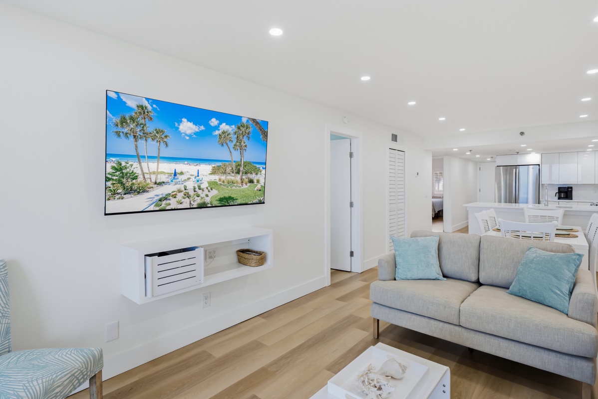 Relax in your bright living room with plush seating, large TV, and coastal-themed decor that creates the perfect beachside retreat.