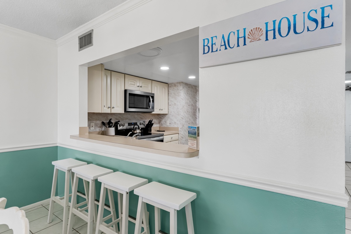 Gather around this coastal-inspired breakfast bar where you can enjoy morning coffee with ocean vibes in your fully-equipped beach house kitchen.