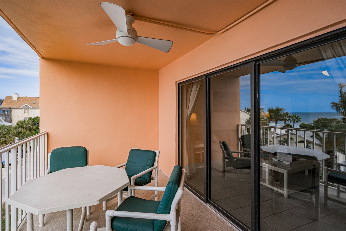 Your private balcony awaits with ocean views, ceiling fan comfort, and dining space perfect for morning coffee or evening relaxation.