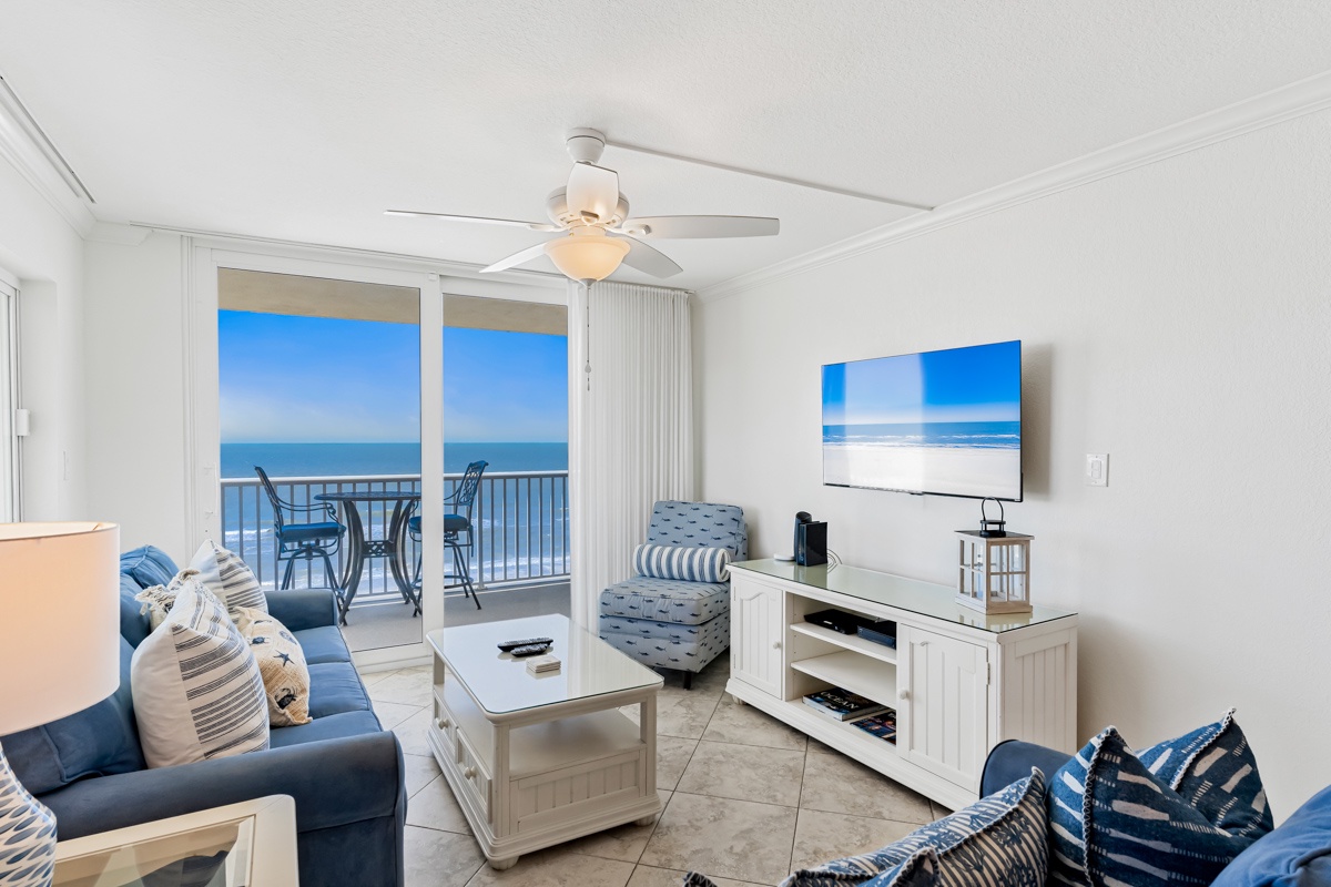 Relax in your bright living room with stunning ocean views through floor-to-ceiling windows, where coastal breezes flow from your private balcony.