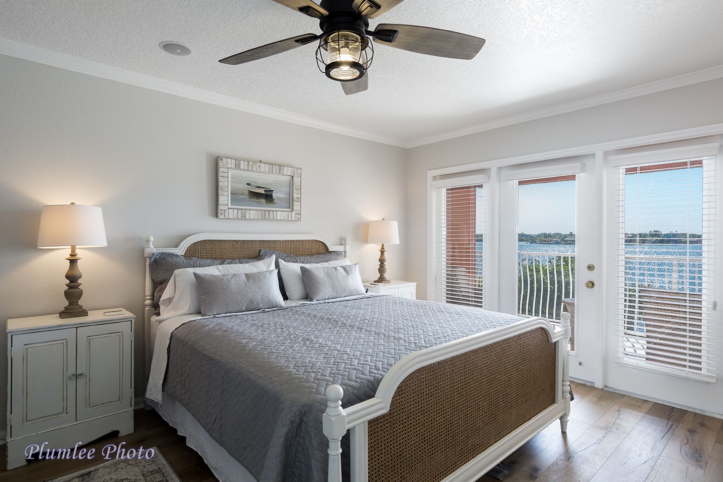 The master bedroom has large windows and glass doors to the 2nd floor balcony.