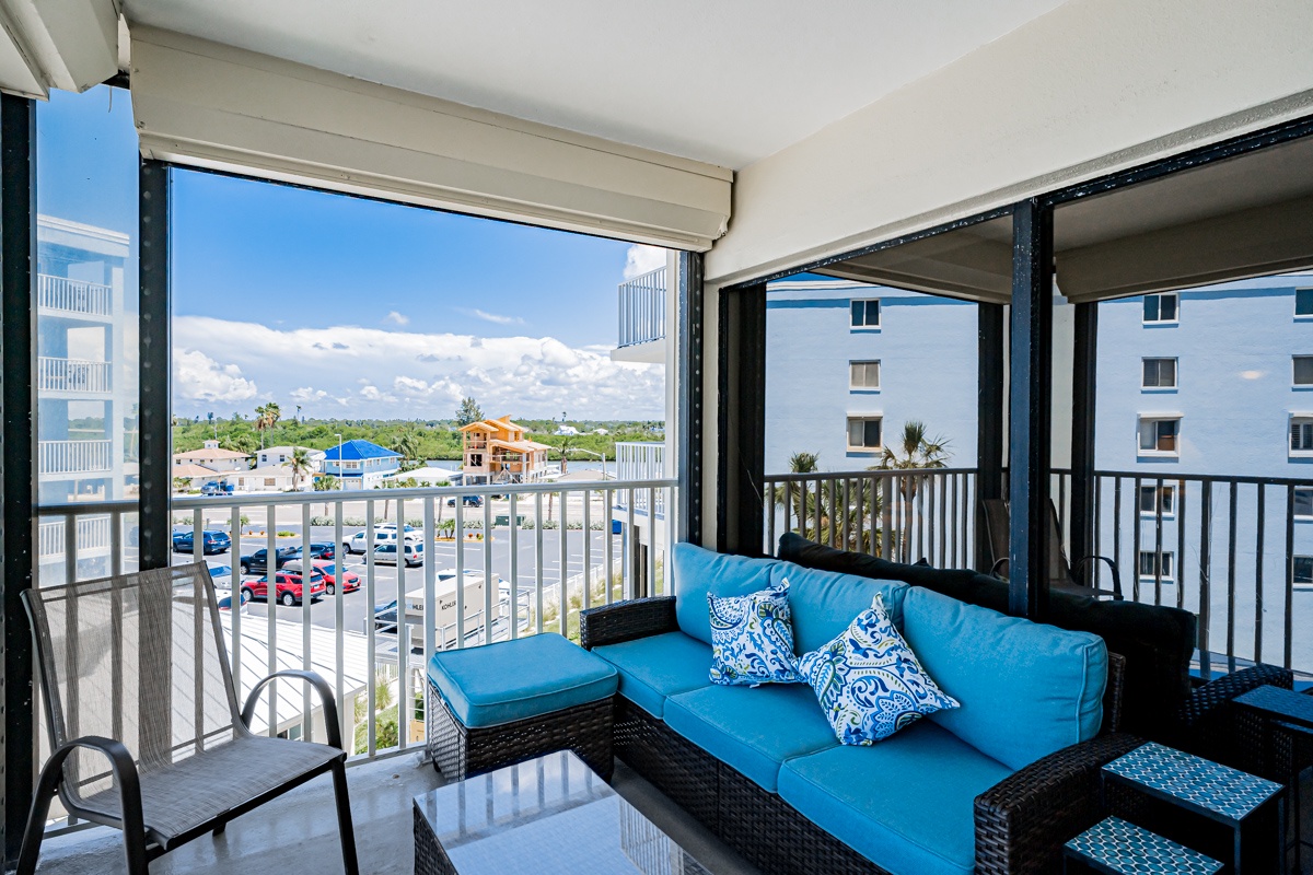 Settle into your private balcony and let the Florida sunshine warm your getaway. Bright blue cushions invite you to unwind with coffee in hand, while breezy palms sway just beyond the railing—your own slice of coastal relaxation.