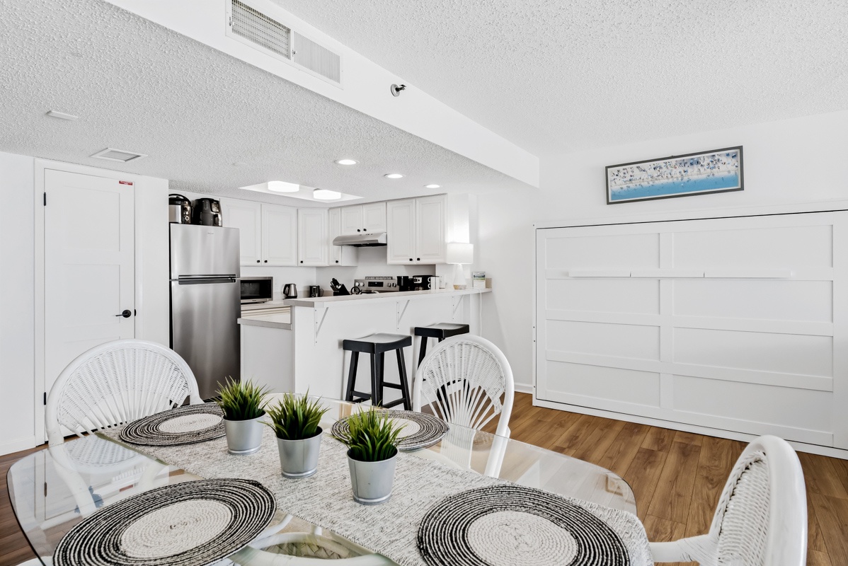 Your bright, open-concept space flows seamlessly from dining to kitchen, where you'll love preparing meals with modern appliances and stylish bar seating.