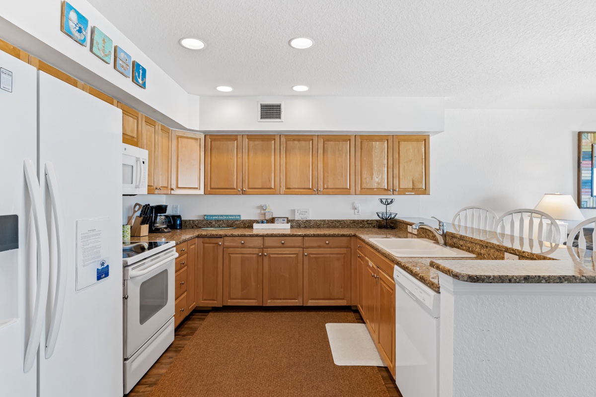 You'll love cooking meals in this fully equipped kitchen featuring granite counters and modern appliances.