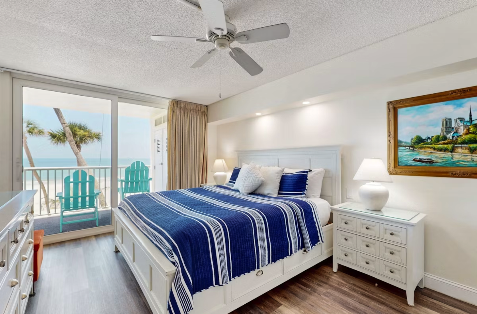 Wake up to gentle sea breezes and stunning ocean views from your private balcony. This serene bedroom features crisp coastal linens, soothing blue accents, and soft lighting for ultimate relaxation.