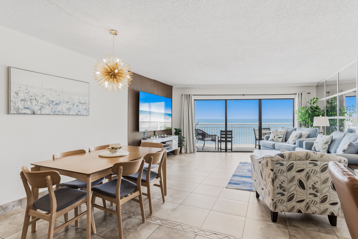 Step into your bright coastal retreat where an airy open-plan living space flows seamlessly toward floor-to-ceiling windows. Your eyes are drawn to the sparkling sea beyond, framed by a private balcony inviting quiet mornings and sundowner moments.
